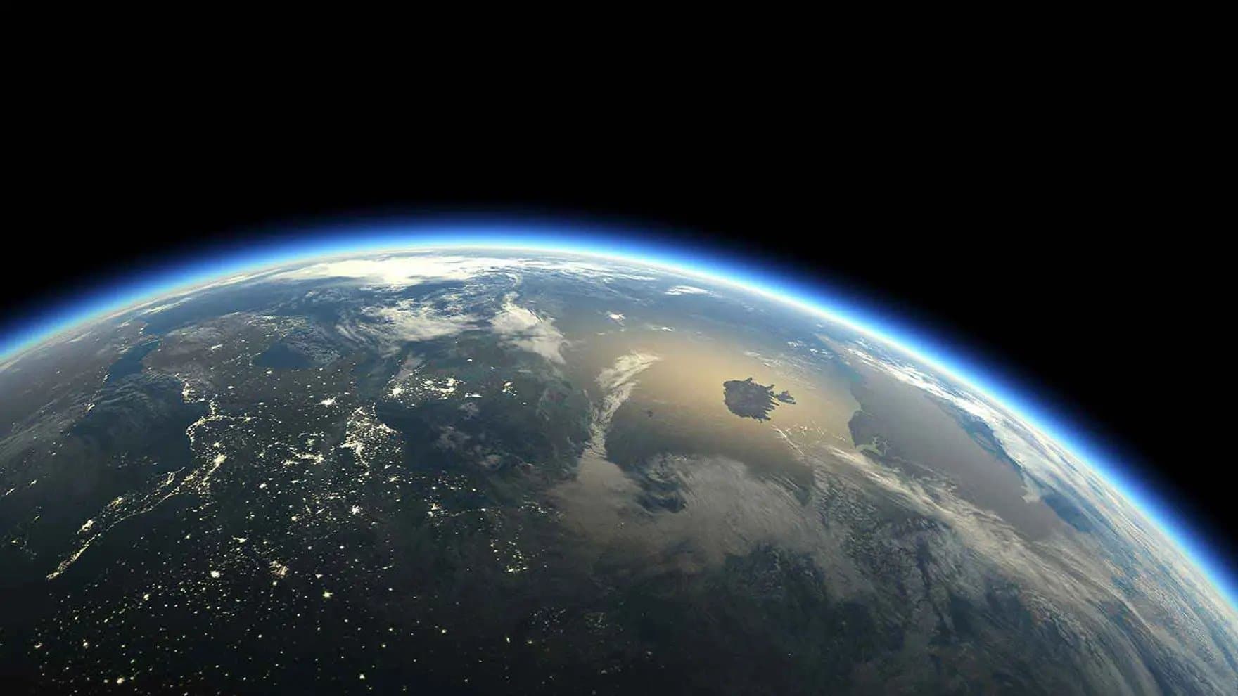 Earth partially illuminated, with city lights visible on darkened landmasses. Clouds and blue atmosphere curve along the horizon against a backdrop of dark space, suggesting a view from orbit.